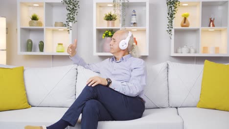 Unhappy-old-man-listening-to-music-with-headphones.